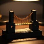 Pont suspendu miniature en laiton reliant deux blocs de pierre sur un bureau