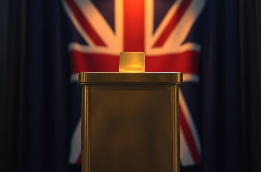 Urne en laiton avec fente pour pieces sur un podium avec drapeau britannique